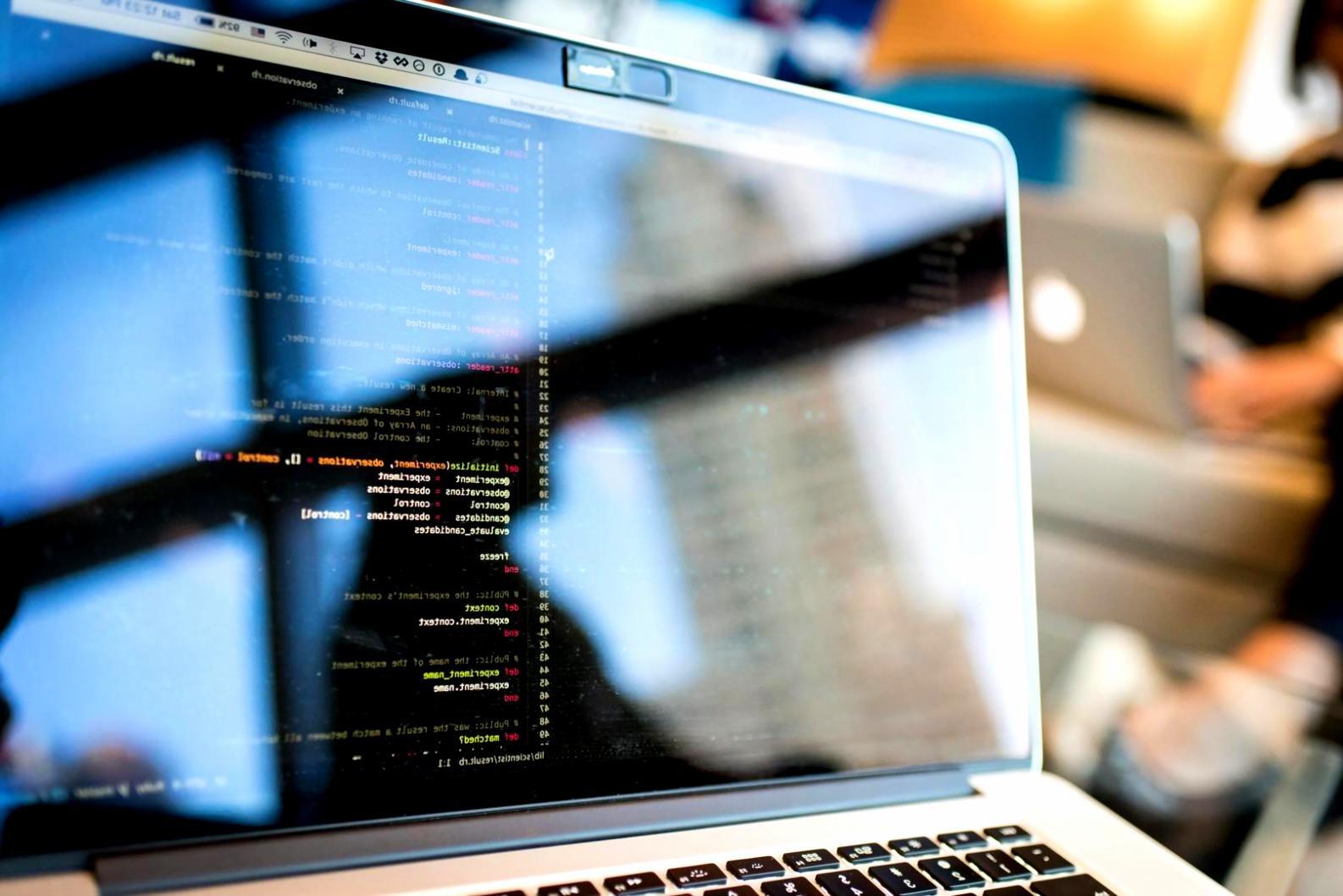 Students collaborating on front-end development projects in modern learning environment